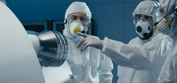 medium shot of engineers discussing about nozzles in clean room